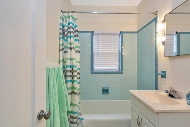 bathroom featuring shower / bathtub combination with curtain and vanity