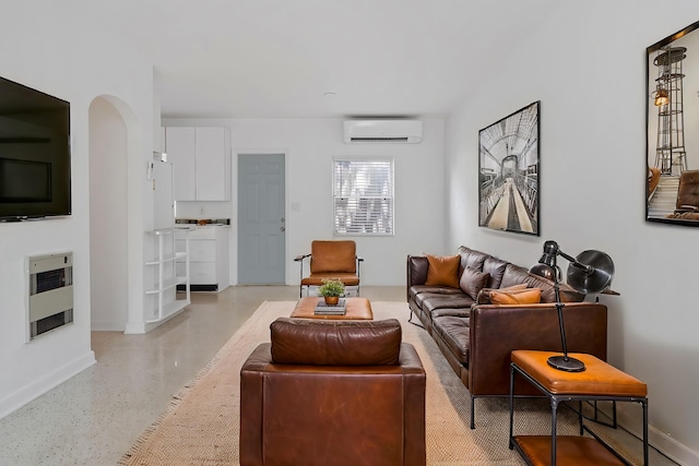 living room with heating unit and a wall mounted air conditioner