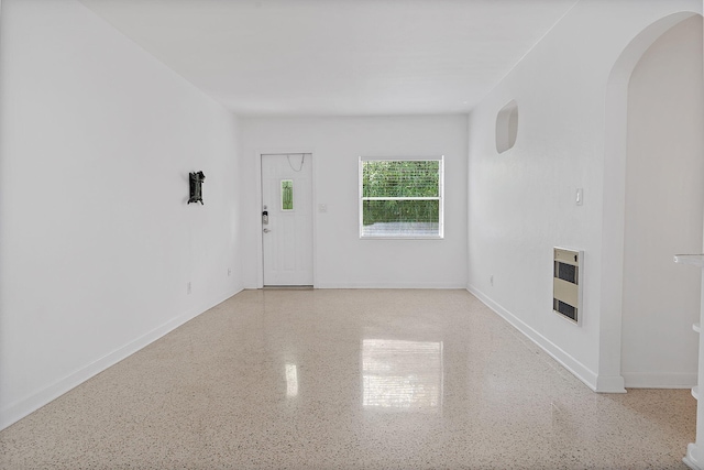 unfurnished living room with heating unit