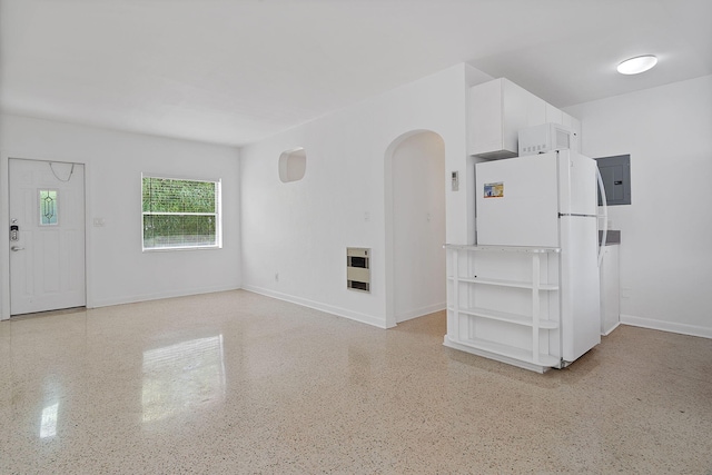 unfurnished living room with electric panel and heating unit