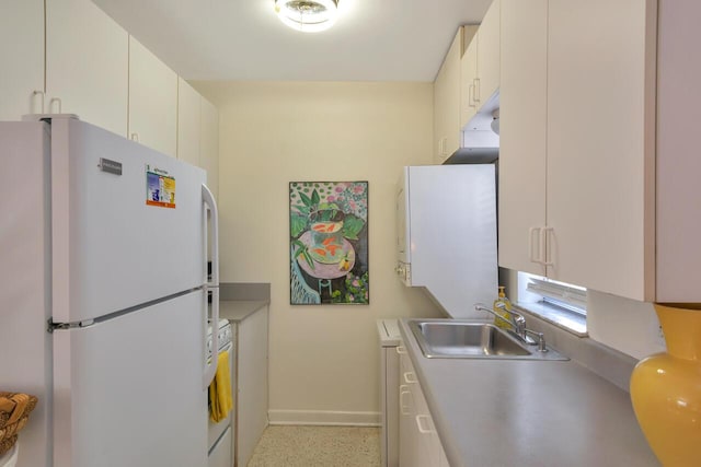 kitchen with white cabinetry, sink, range, and white refrigerator