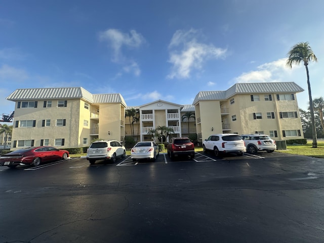 view of building exterior featuring uncovered parking