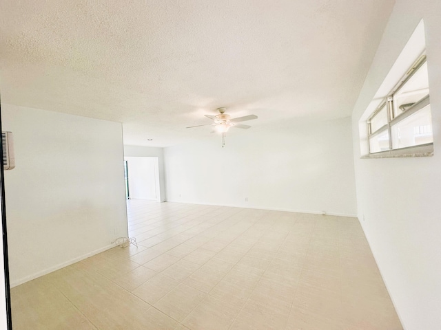 empty room featuring ceiling fan and a textured ceiling