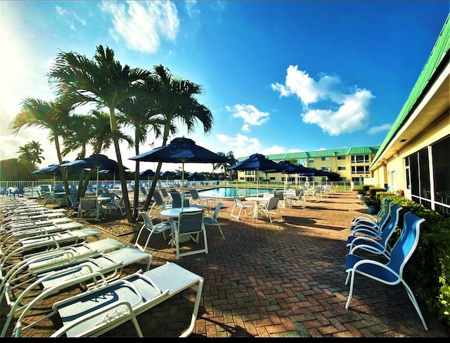 view of patio / terrace featuring a community pool and fence