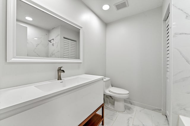 bathroom featuring toilet, vanity, and walk in shower