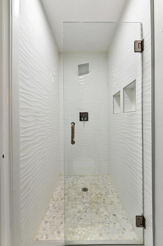 bathroom with a shower with shower door