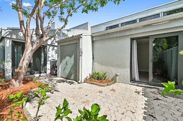 property entrance featuring a patio area