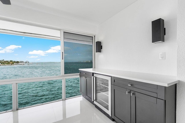 balcony featuring a water view and wine cooler