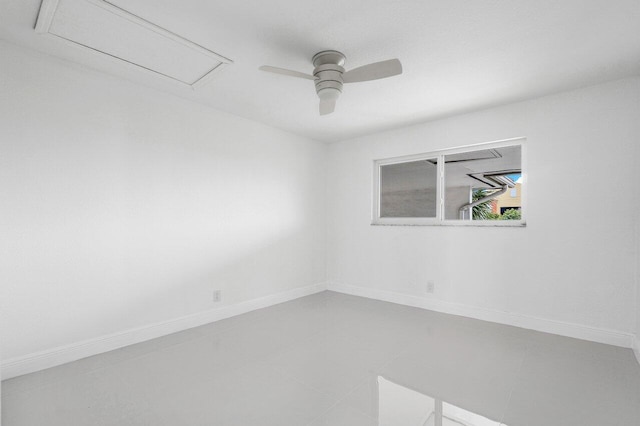 empty room featuring ceiling fan and tile patterned flooring