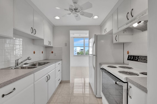 kitchen featuring white electric range, sink, white cabinetry, light tile patterned floors, and backsplash