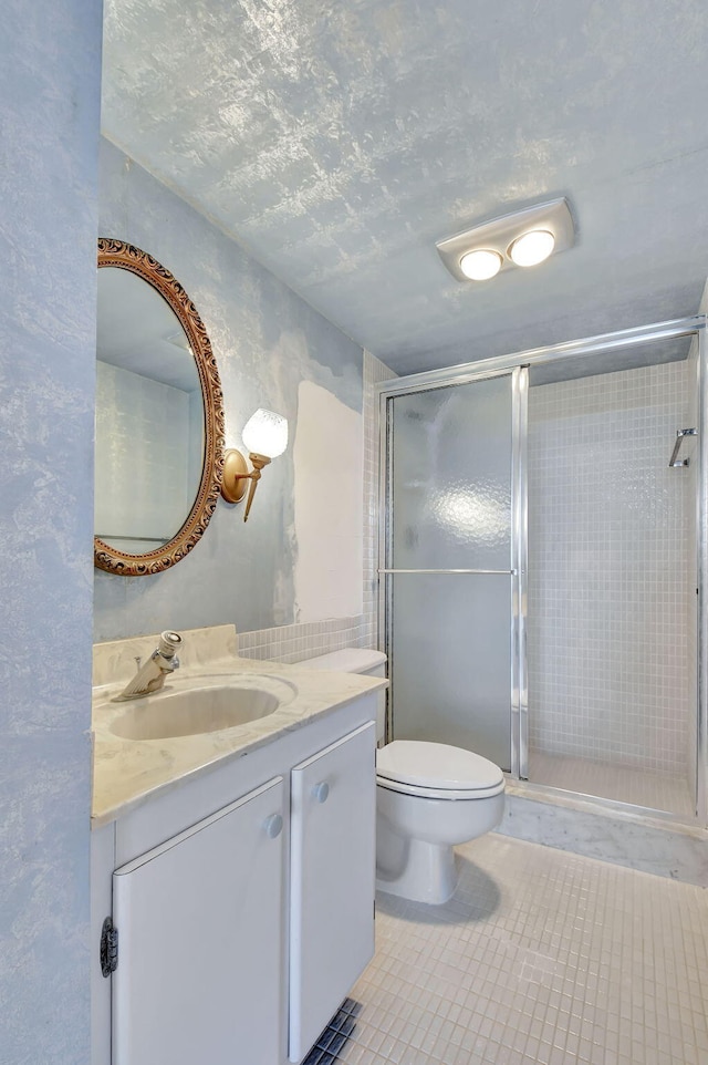 bathroom with walk in shower, toilet, a textured ceiling, vanity, and tile patterned flooring