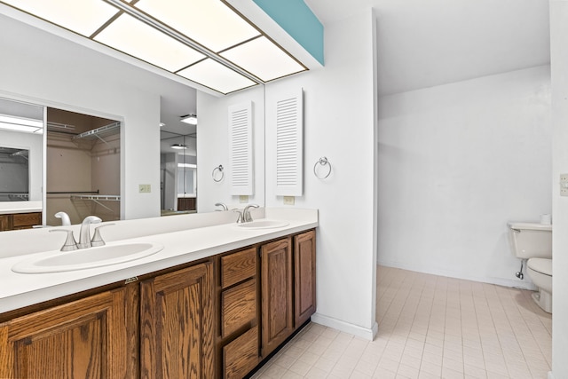 bathroom featuring toilet and vanity