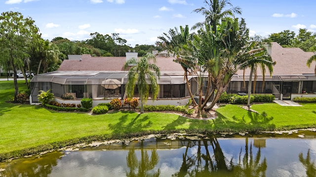 exterior space featuring a water view and a lawn