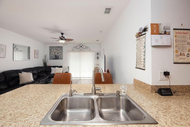 kitchen featuring ceiling fan and sink