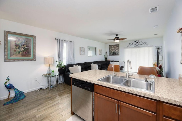 kitchen with ceiling fan, dishwasher, sink, and light hardwood / wood-style floors