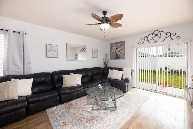 living room featuring ceiling fan and hardwood / wood-style floors