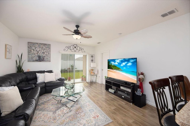 living room with light wood-type flooring and ceiling fan