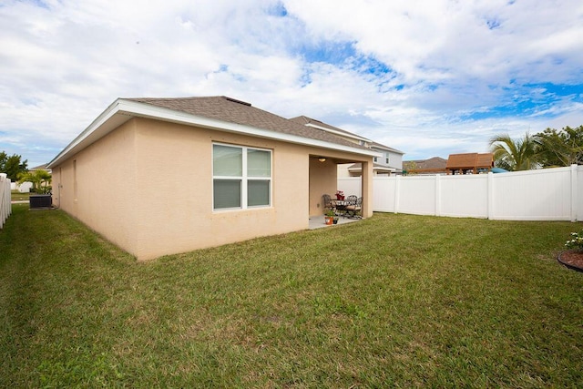 back of property featuring central AC, a lawn, and a patio