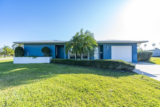 single story home with a garage and a front lawn