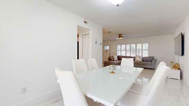 dining space featuring ceiling fan