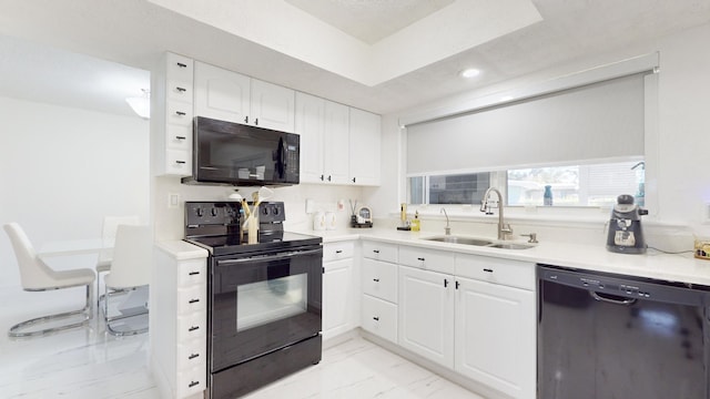 kitchen with sink, white cabinets, and black appliances