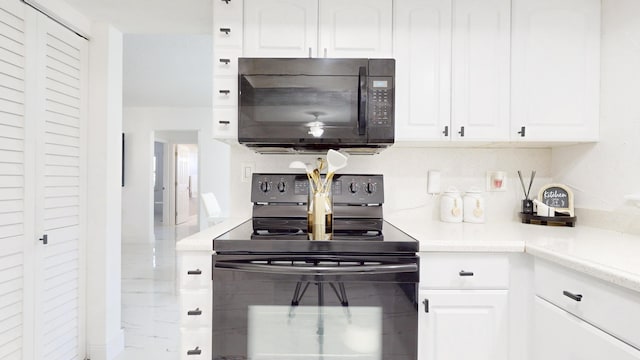 kitchen featuring black appliances and white cabinets