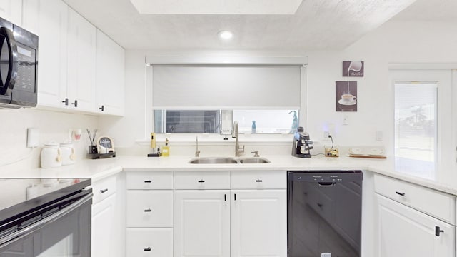 kitchen featuring dishwasher, sink, and white cabinetry