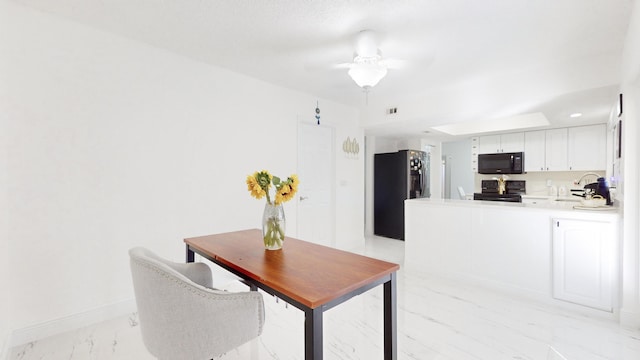 kitchen with ceiling fan, black appliances, kitchen peninsula, sink, and white cabinets