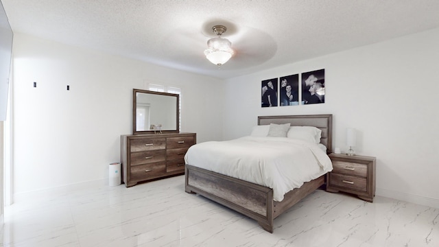 bedroom featuring a textured ceiling and ceiling fan