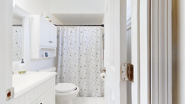 bathroom featuring tile patterned floors, toilet, vanity, and walk in shower