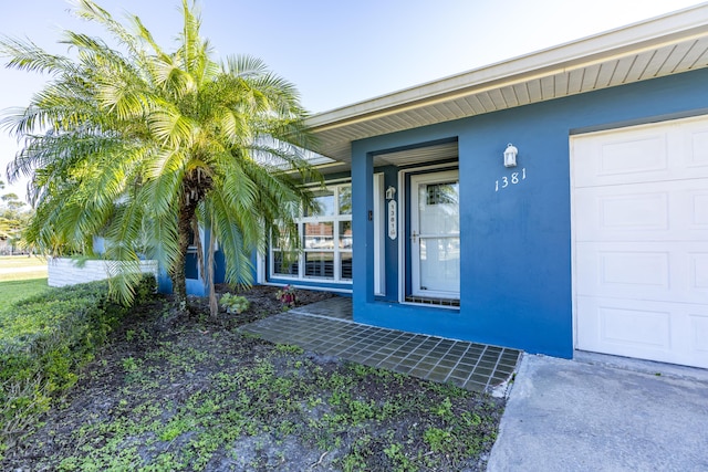 view of exterior entry featuring a garage