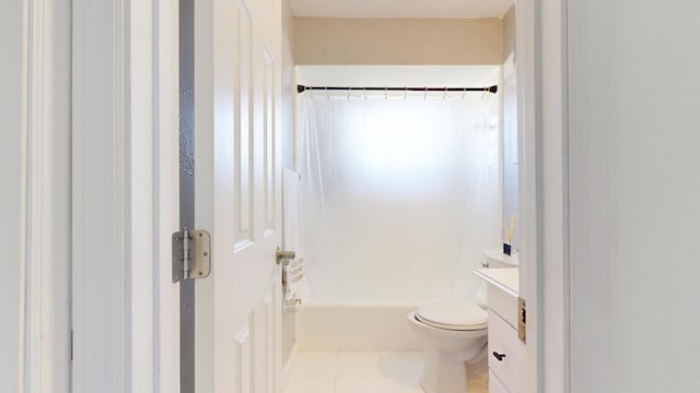 full bathroom featuring toilet, vanity, tile patterned flooring, and shower / bathtub combination with curtain