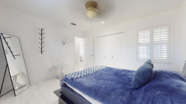 bedroom featuring ceiling fan and a closet