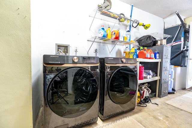 laundry room featuring washing machine and dryer and a textured ceiling