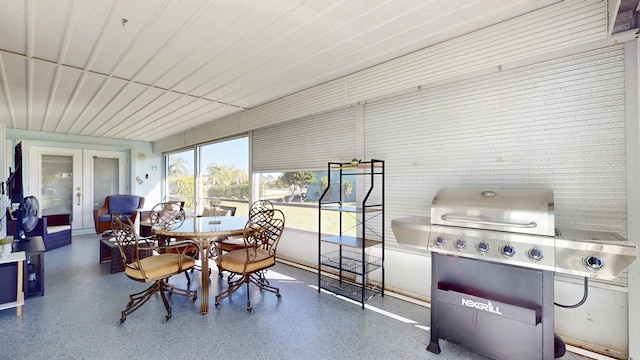 sunroom / solarium featuring french doors