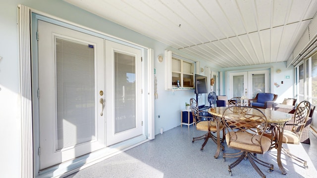 sunroom / solarium featuring french doors