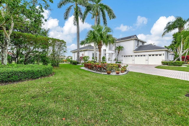 view of front of home featuring a garage and a front yard