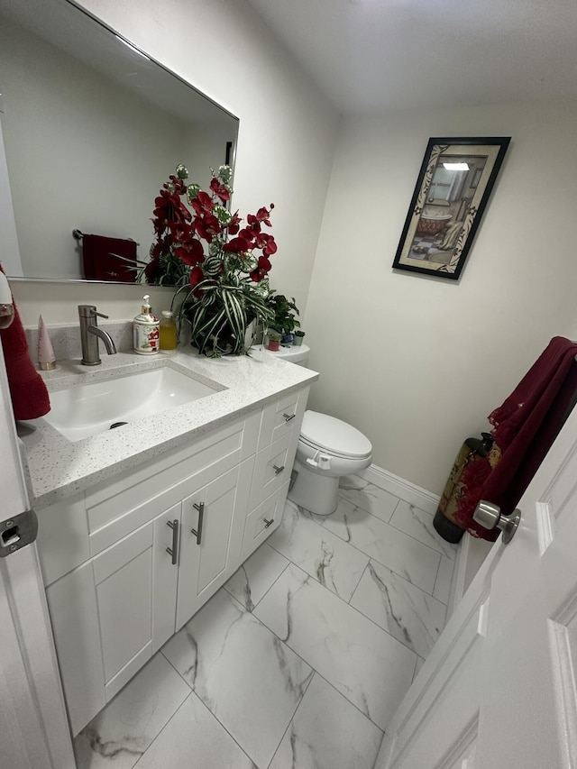 bathroom with toilet and vanity