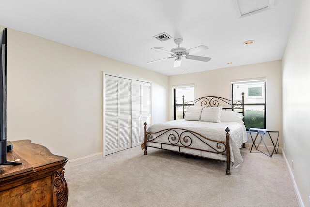 carpeted bedroom featuring ceiling fan and a closet