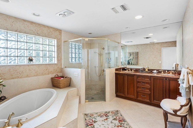 bathroom featuring separate shower and tub, vanity, and tile patterned flooring