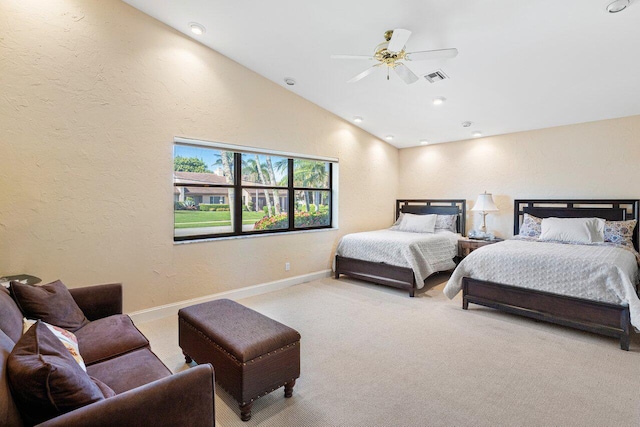 bedroom featuring ceiling fan, vaulted ceiling, and light carpet