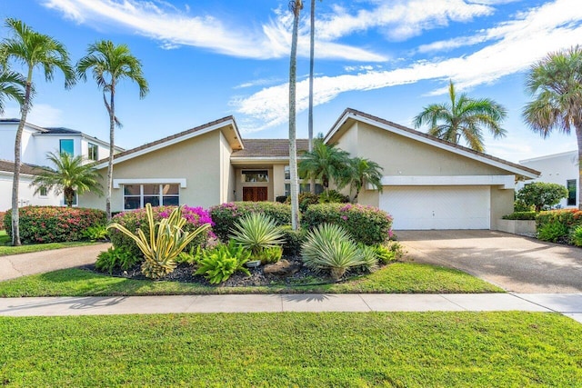 single story home with a front lawn and a garage