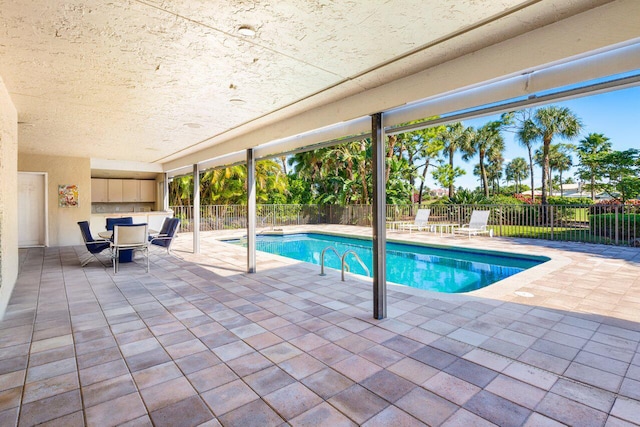 view of swimming pool with a patio area