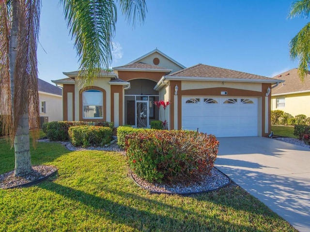 view of front of home with a garage and a front lawn