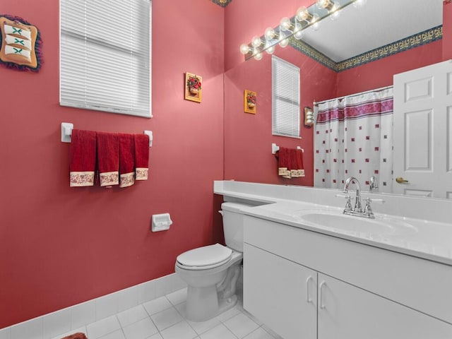 bathroom featuring toilet, vanity, tile patterned flooring, and a shower with shower curtain