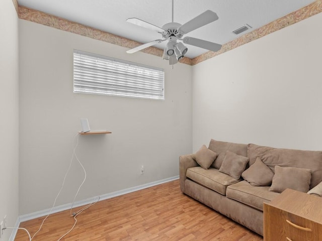 living room with ceiling fan and hardwood / wood-style floors