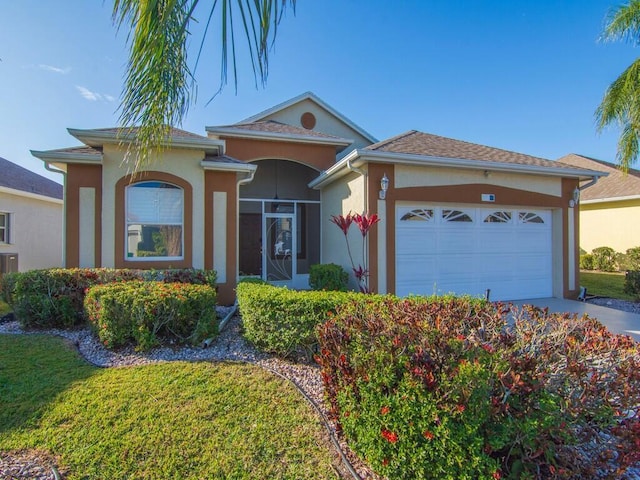 ranch-style home featuring a front lawn and a garage