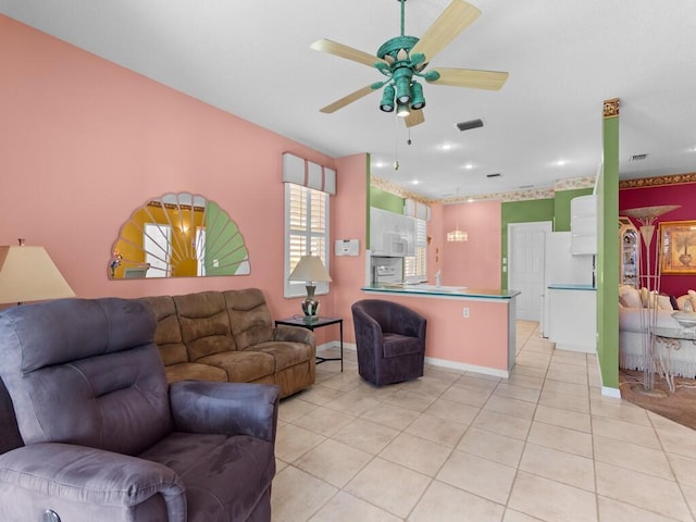 living room with ceiling fan and light tile patterned floors