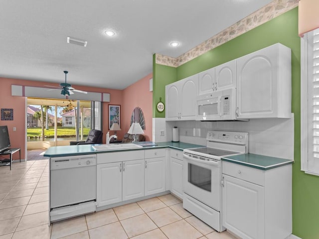 kitchen featuring white cabinetry, kitchen peninsula, and white appliances