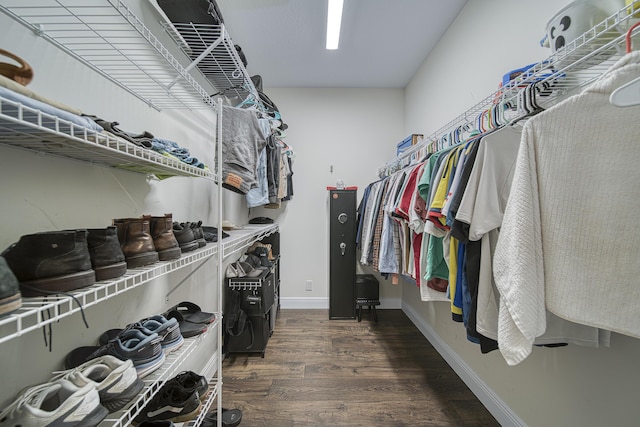 spacious closet with dark hardwood / wood-style flooring